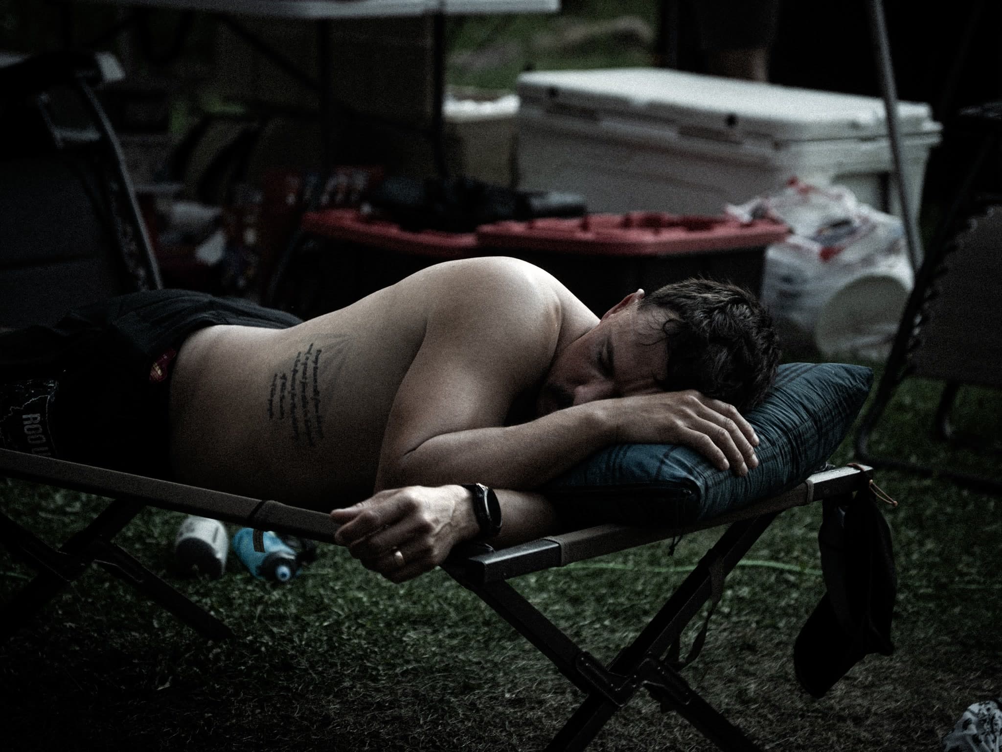 An exhausted runner resting between loops during the ROO Ultra
