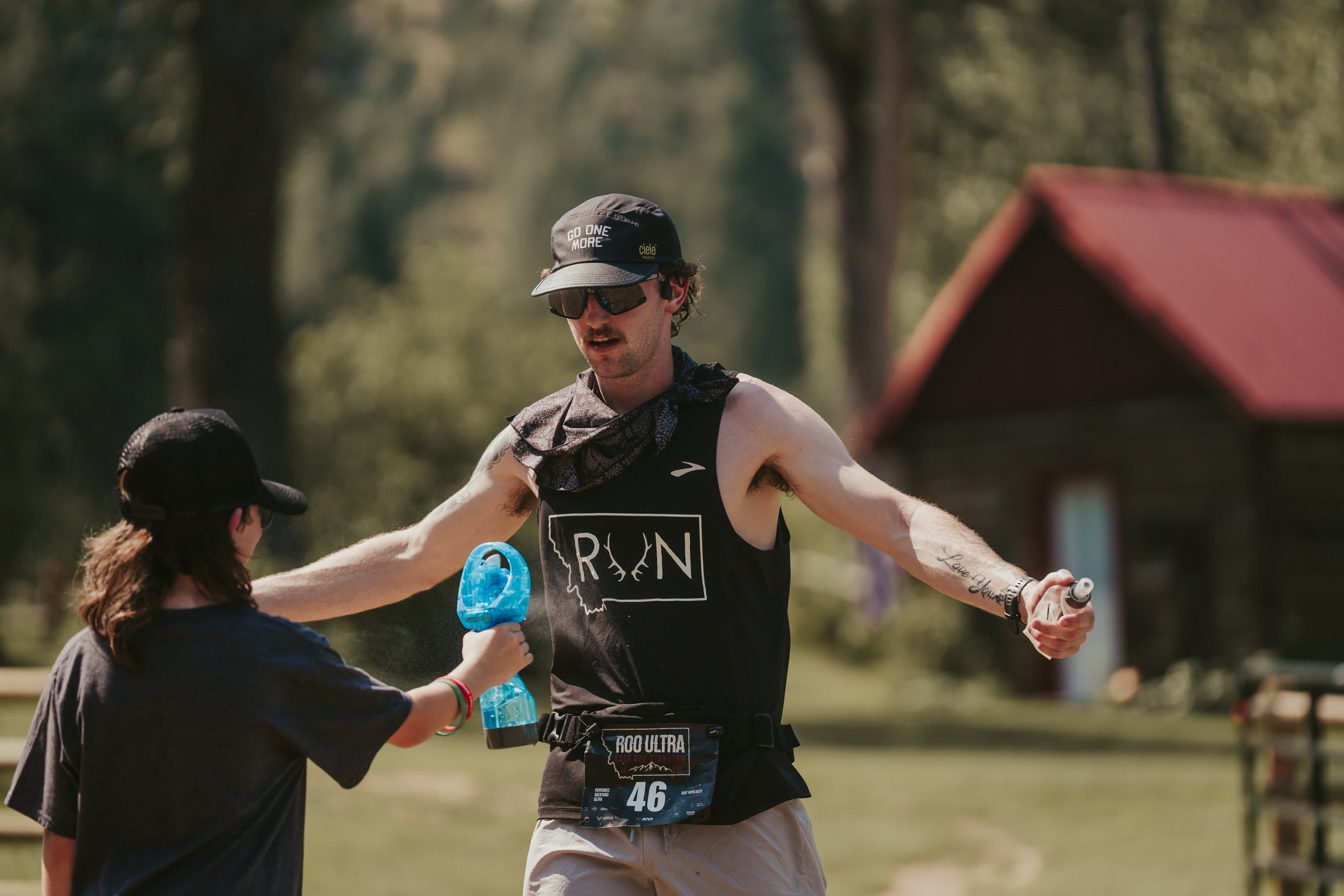 A runner receiving support from crew mid-loop
