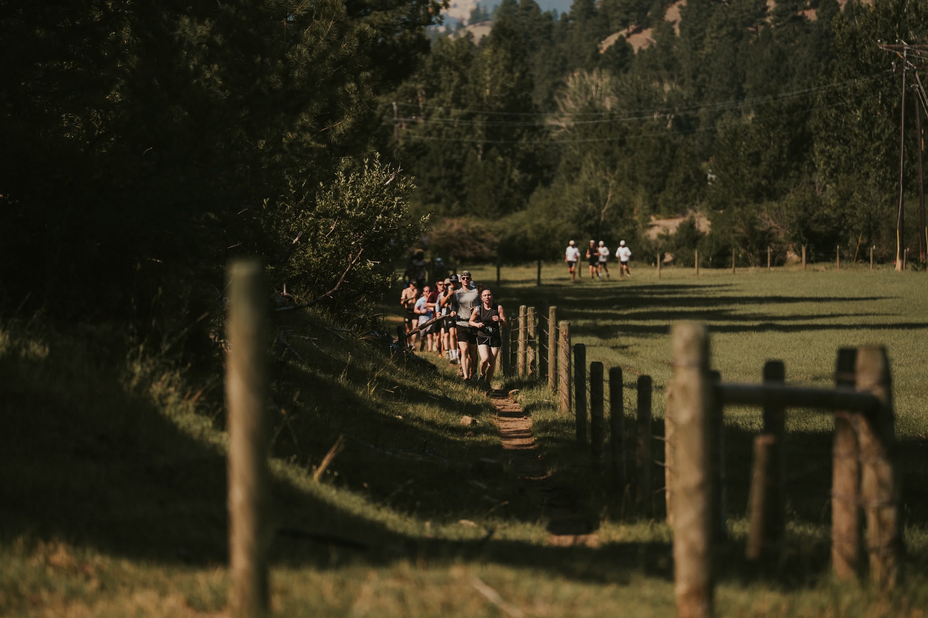 Runners disappearing along a trail through the Montana backcountry