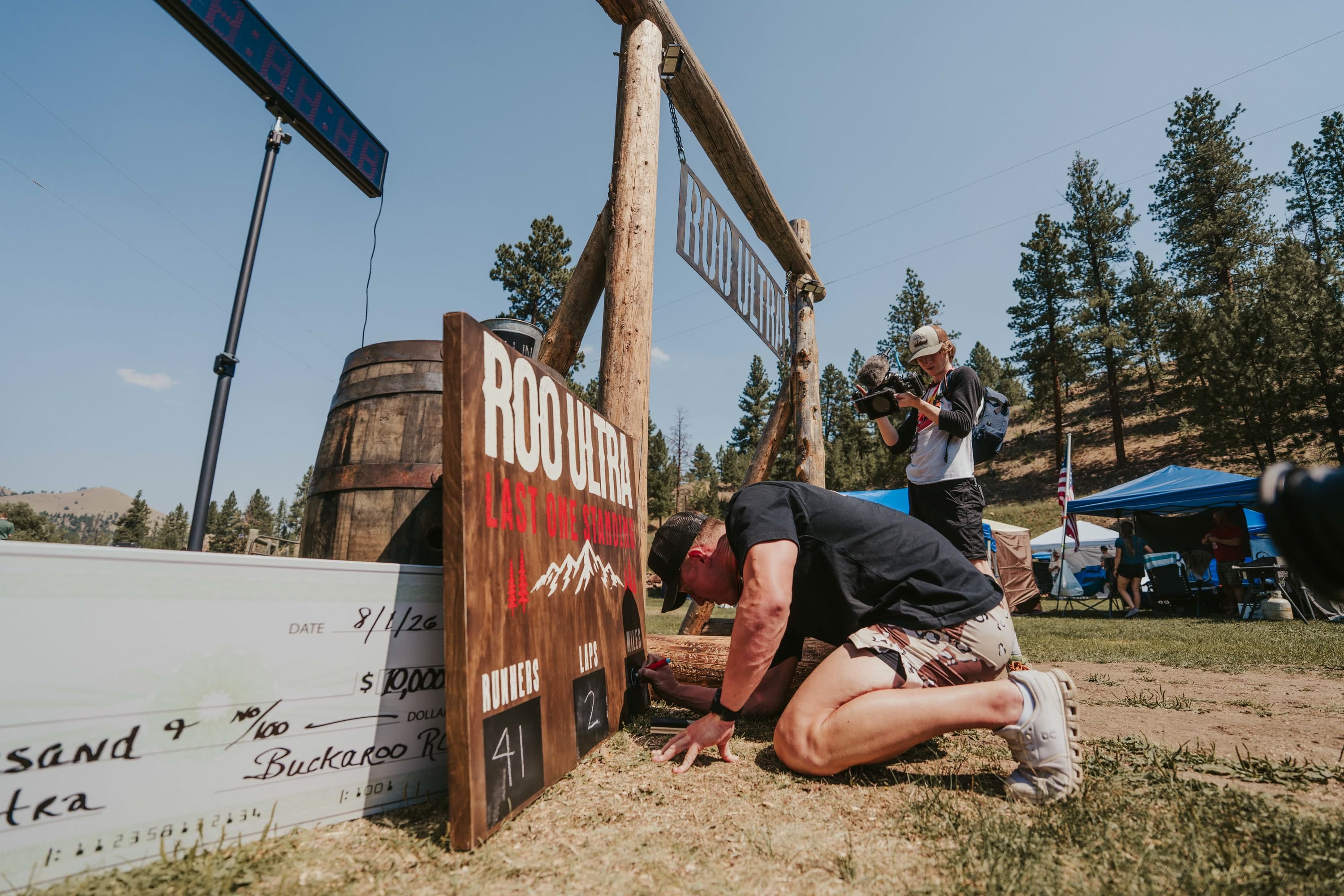 Crew updating the runner and lap count board during the early hours of the ROO Ultra
